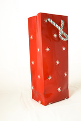 Red gift bag with stars isolated against white background