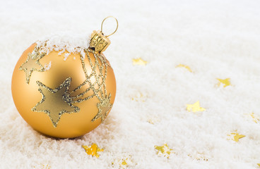 Golden Christmas ball on snow
