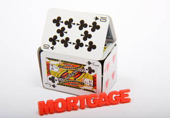 Playing cards made into a house with the word mortgage