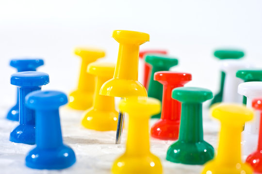 group of colorful office pins on white background