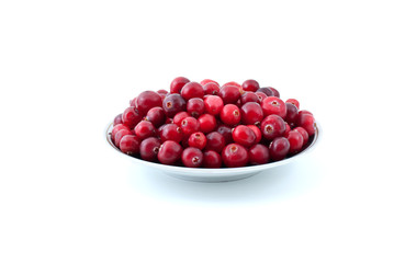 Saucer filled with ripe cranberries isolated on the white