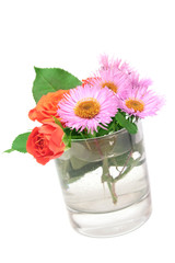 Small roses and daisies in a glass.