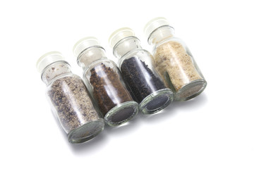 Row of Spice Bottles on White Background