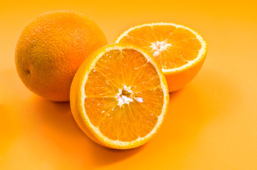 group of oranges on yellow background