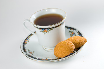 Cup of tea and cookies isolated