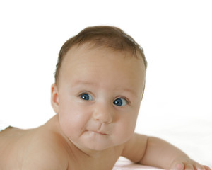 baby with "oops" expression on face, white background