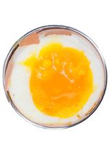 brown egg in an eggcup on white background