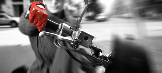 Young woman on the bike, motion blurred (focus on the hand)