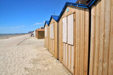 Wooden beach huts with blue roof