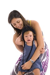 Mother holding a crying baby on white .