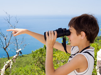 A child looking through binoculars