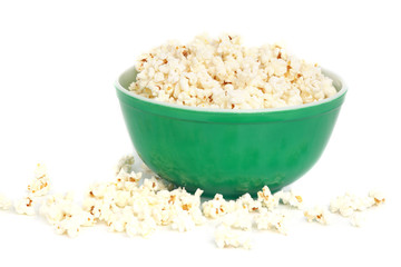 fresh popcorn on green bowl, white background