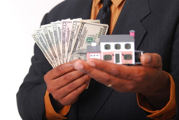 African-American male hands holding a miniature house