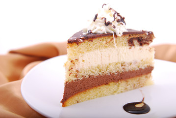Mousse cake on a white plate garnished with chocolate