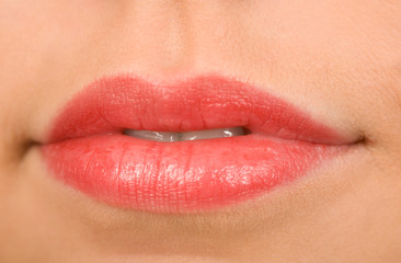 Fototapeta premium the female lips with cosmetics macro shot