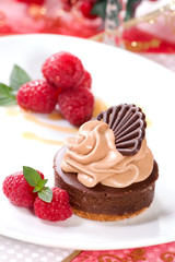 chocolate cheesecake served with fresh raspberries and mint