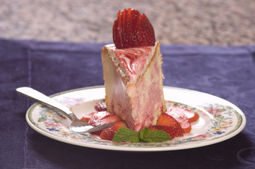 Plate of strawberry cheescake with fresh strawberries