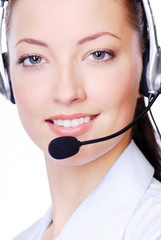 Close-up face of young adult woman in headphones on a white