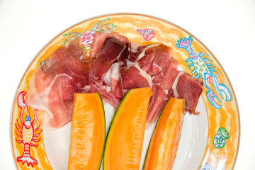 Prosciutto di Parma ham and three slice of melon Melon