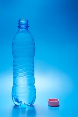 Open water bottle on a blue background