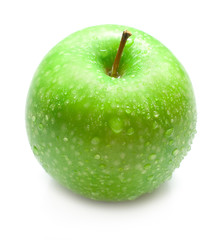 Green apple covered by water drops on the white