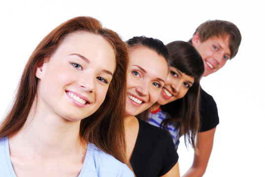 Row of  face of four young smiling teens on white background