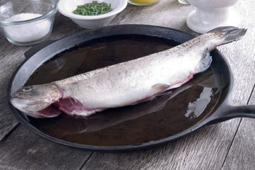 Freshly caught trout in a greased cast iron pan