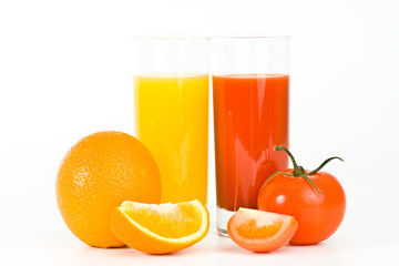 Orange and tomato fruits with juice in the glass, isolated
