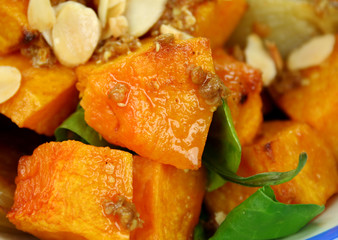 Roasted pumpkin and onion salad with spinach and almonds.
