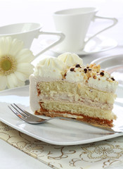 Piece of delicious sweet cake for with cups of tea