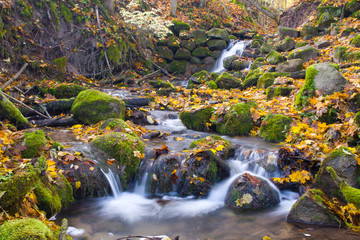 Fototapeta na wymiar beautiful cascade waterfall in autumn forest