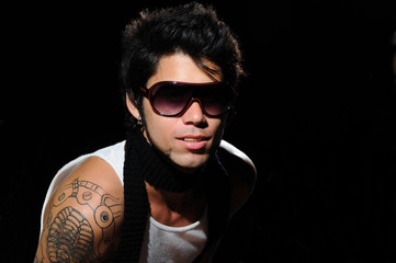 Fototapeta premium Portrait of young male fashion model with arm tattoo