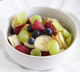 bowl of cereal with lots of  fresh fruit