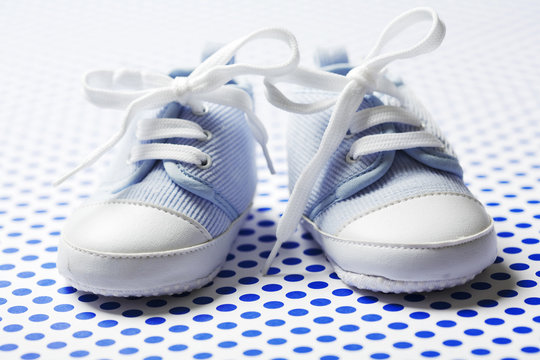 Ltlle Cute Baby Shoes On A Blue Pattern
