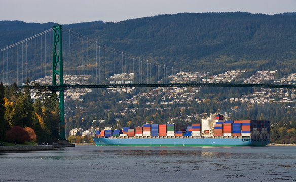 Large container ship   under the Lions Gate  Bridge