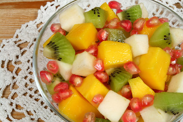 Fruit salad with kiwi, mango, pear and pomegranate