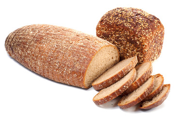 loafs of whole wheat and  rye bread on light background