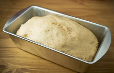 Fresh whole wheat dough in a baking pan