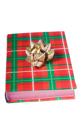 Book traditional Christmas colors with golden bow on top