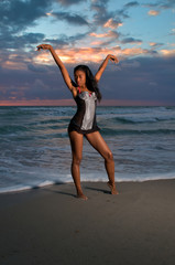 A young multi-racial girl practices yoga and relaxes