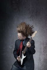 Emotional photo of the man playin on electric guitar