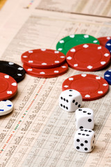 dice and casino chips on a stock market chart