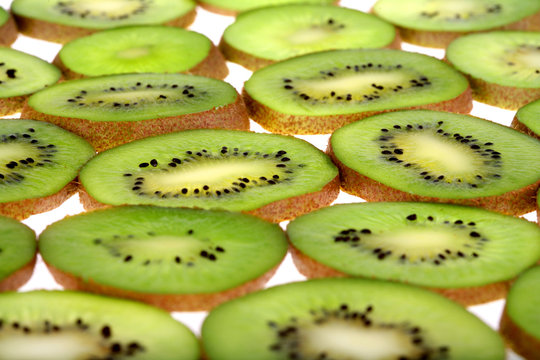 Background of juicy fresh sliced kiwi on white