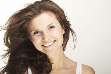 Fototapeta premium A happy young woman with facial expression on white background