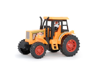 Small yellow toy tractor isolated on white