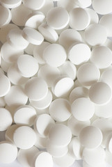 white round vitamins on the white isolated background