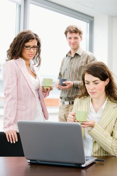 Team of young successful office workers talking