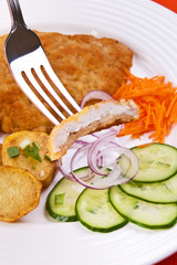 Fried chop pork with potatoes and vegetable salad