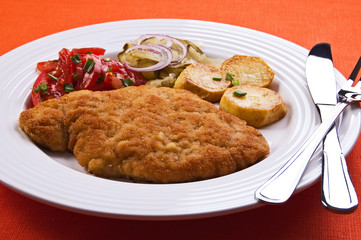 Fried chop pork with potatoes and vegetable salad
