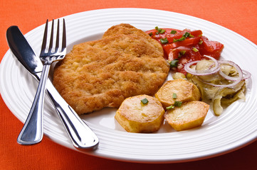 Fried chop pork with potatoes and vegetable salad